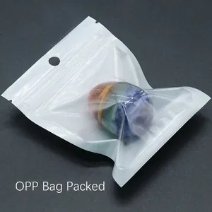 Handcrafted chakra egg made of colorful tiger eye stone layers in a protective OPP bag