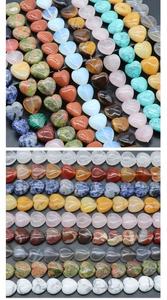 Detailed view of heart-shaped polished gemstone beads in various natural stones for jewelry