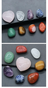 Macro view of polished seven chakra natural crystal stones with a heart-shaped rose quartz