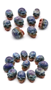 Detailed macro view of colorful carved natural crystal skulls with polished mineral textures