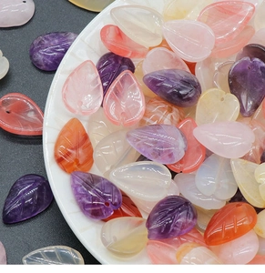 Detailed view of colorful leaf-shaped crystal beads with realistic carved veins for DIY jewelry