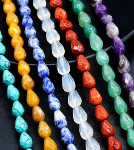 Macro shot of 7x10mm faceted teardrop natural stone beads in various vibrant colors