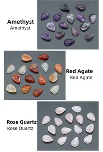 Macro shot of leaf-shaped amethyst, red agate, and rose quartz beads for DIY crafts