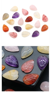 Macro detail of carved leaf gemstone beads showing fine texture for jewelry DIY