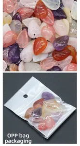 Detailed view of carved leaf semi-precious stones with pre-drilled holes in OPP bag