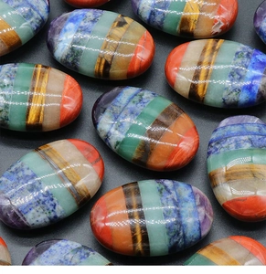 Close-up of polished oval chakra stones with 7-layer gemstone stitching for meditation