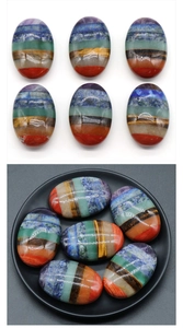 Polished seven chakra energy stones in an oval shape for meditation and healing