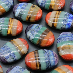 Polished flat oval seven chakra energy stones set made of layered natural crystals