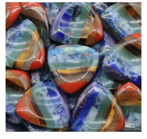 Vista macro di pietre chakra triangolari con sette strati minerali colorati e finitura lucida