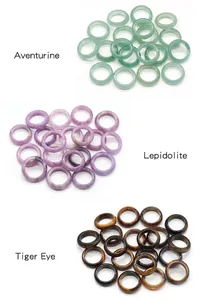 Close-up of natural Aventurine, Lepidolite and Tiger Eye stone rings with polished finish