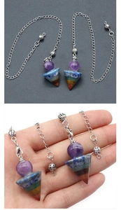Close-up of 7 chakra natural stone pendulum with amethyst ball and hexagonal cone design