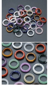 Detailed view of polished natural crystal and agate rings in various mineral stones