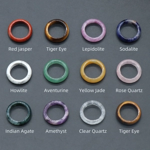 Variety of natural crystal and agate rings including tiger eye and amethyst