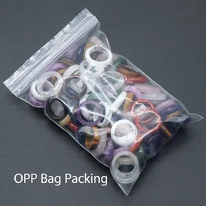 Multiple natural stone agate rings in diverse colors showcased in clear OPP bag packaging