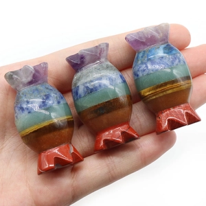 Polished candy-shaped seven chakra stones carved from layered natural crystals and gemstones