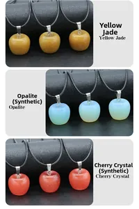 Detailed view of apple-shaped pendants in yellow jade, opalite, and red crystal