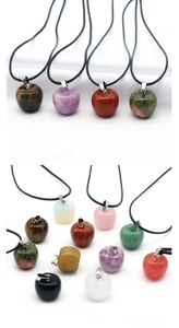 Macro detail of apple-shaped natural crystal pendants with various semi-precious stones
