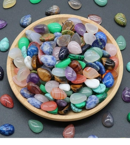 Close-up of assorted teardrop natural crystals and gemstones for jewelry making