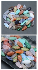 Macro shot of assorted teardrop crystal cabochons showing polished textures and colors