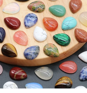 Macro view of assorted teardrop natural stone cabochons for DIY jewelry inlay
