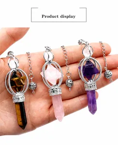 Close-up of Amethyst, Rose Quartz, and Tiger Eye hexagonal crystal pendant pendulums