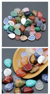 Polished teardrop shaped natural crystals and gemstones displayed in a wooden spoon