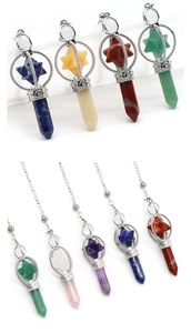Detailed view of assorted crystal hexagonal pendants with hollow metal Merkaba cages