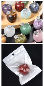 Detailed view of various crystal apple ornaments and individual transparent bag packaging