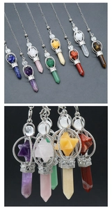 Macro shot of natural crystal pendants with Merkaba stars and hexagonal prisms in silver frames