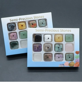 Macro detail of natural semi-precious stone cube beads in a 12-slot storage display box
