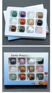 Detail of 12 mini semi-precious stone apples in a display box with metal leaf accents
