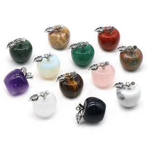 Set of 12 natural crystal apple pendants with silver metal leaf charms on white background
