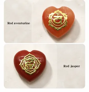 Detail of heart-shaped red aventurine and red jasper stones with gold chakra symbols