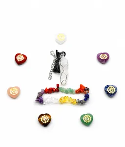Detail view of 7 chakra heart stones, chip bracelet, and crystal pendant on white background