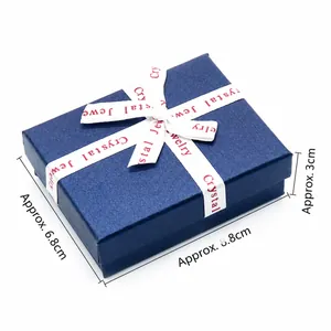 Dark blue chakra crystal jewelry gift box with white ribbon bow and textured finish