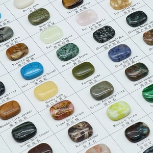 Collection of 100 polished natural crystals and synthetic gemstones in white display tray