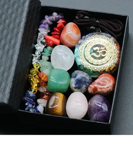 Macro shot of 7 Chakra healing crystals set with Orgone Om pendant in a textured gift box