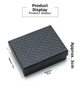 Detail of a black textured jewelry box with diamond pattern measuring 9x7x3cm