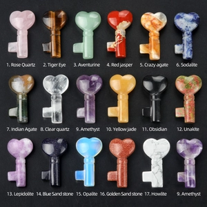 Collection of carved natural crystal heart keys in rose quartz, tiger eye, and amethyst