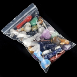 Polished natural crystal stone set with heart and key shapes in multiple gemstones