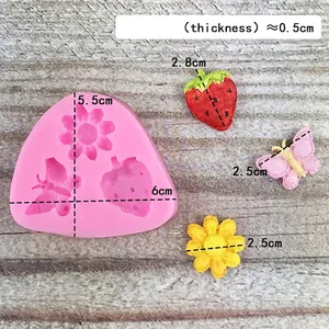 Pink silicone mold with butterfly, strawberry and sunflower shapes for DIY cake baking