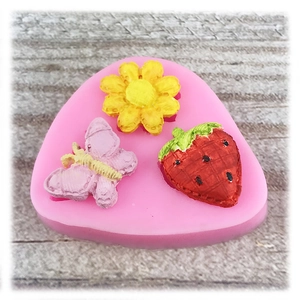 Pink silicone cake mold featuring butterfly strawberry and flower shapes for DIY baking