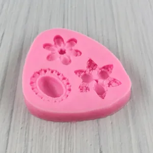 Pink silicone flower mold for fondant and clay DIY crafts on a wooden surface