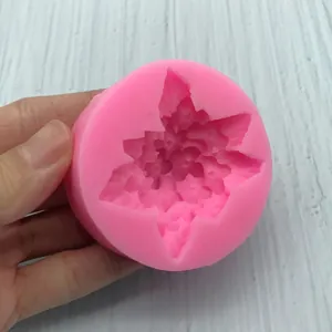 Pink silicone mold for daisy flower resin craft and aroma stone making on wood background