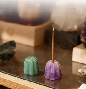 Macro detail of hand-carved natural aventurine stone flower incense holder with hole