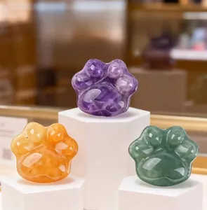 Macro shot of polished natural crystal cat paw stones in purple, orange, and green shades