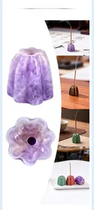 Macro view of pumpkin-shaped crystal incense holders in amethyst and tiger eye stone