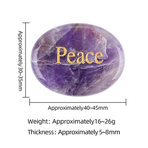Oval purple amethyst power stone with gold Peace engraving and natural stone texture