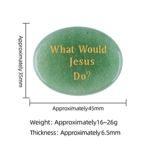 Oval green crystal thumb stone with golden What Would Jesus Do engraving on white background