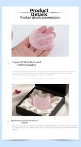 Detailed view of polished rose quartz cat head massager with black satin gift box packing